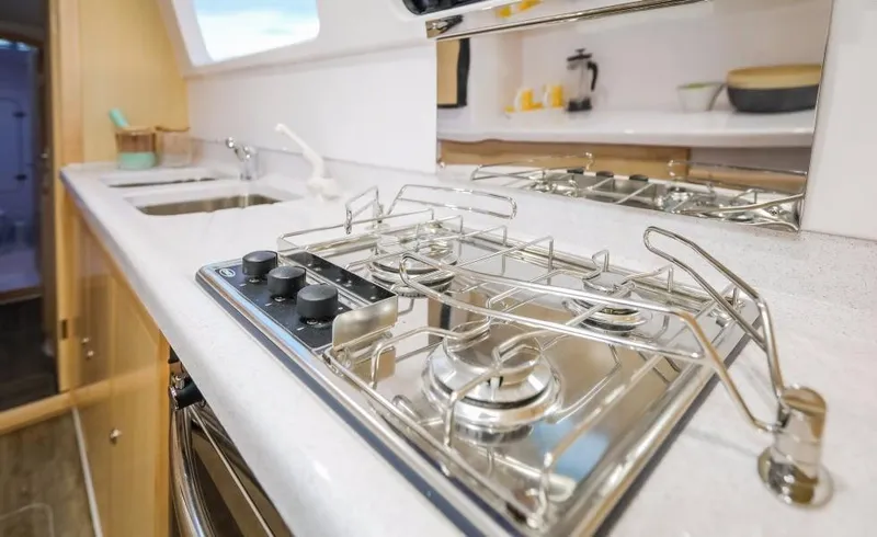 Slide: The Image of Modern kitchen in 2024 Seawind 1260 Owners Version catamaran with stainless steel stove. - 33