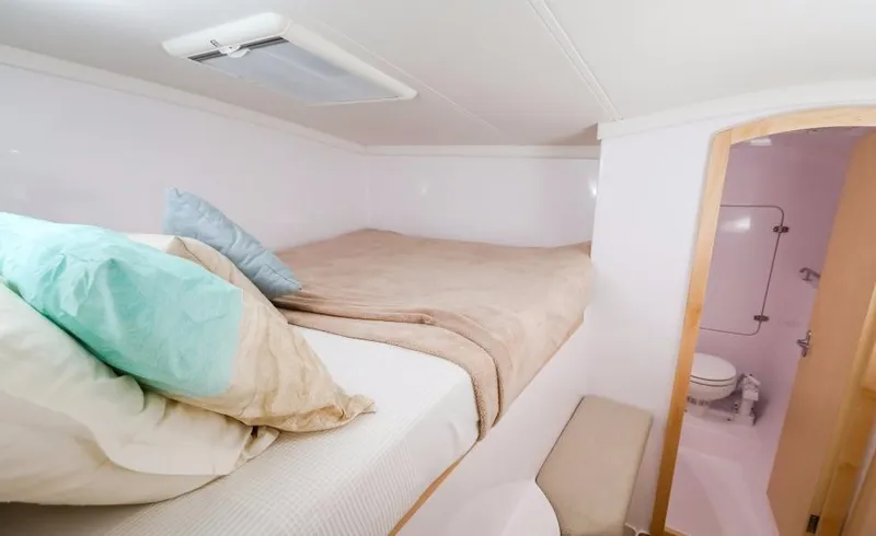 Slide: The Image of 2024 Seawind 1260 Owners Version cabin with bed and ensuite bathroom. - 34