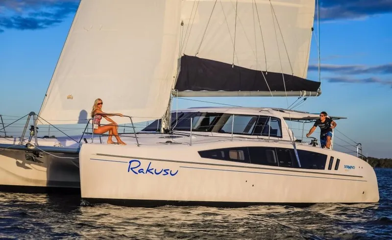 Slide: The Image of 2024 Seawind 1260 Owners Version catamaran sailing on the water at sunset. - 8