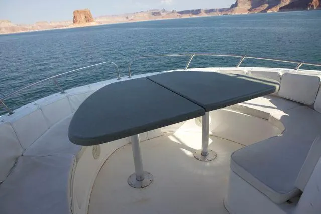 Slide: The Image of Sumerset 2006 Seas The Day Trip 4 boat deck with seating and table, scenic water view. - 2