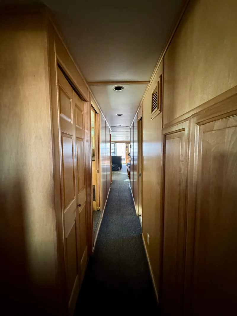 Slide: The Image of Narrow hallway inside 2006 Sumerset Seas The Day Trip 4 houseboat, featuring wooden paneling. - 32
