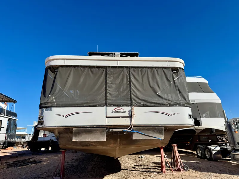 Slide: The Image of 2006 Sumerset Seas The Day Trip 4 houseboat on dry dock under clear blue sky. - 42