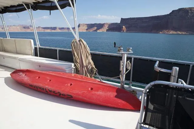 Slide: The Image of Sumerset 2006 houseboat deck with red kayak, overlooking scenic lake and cliffs. - 6