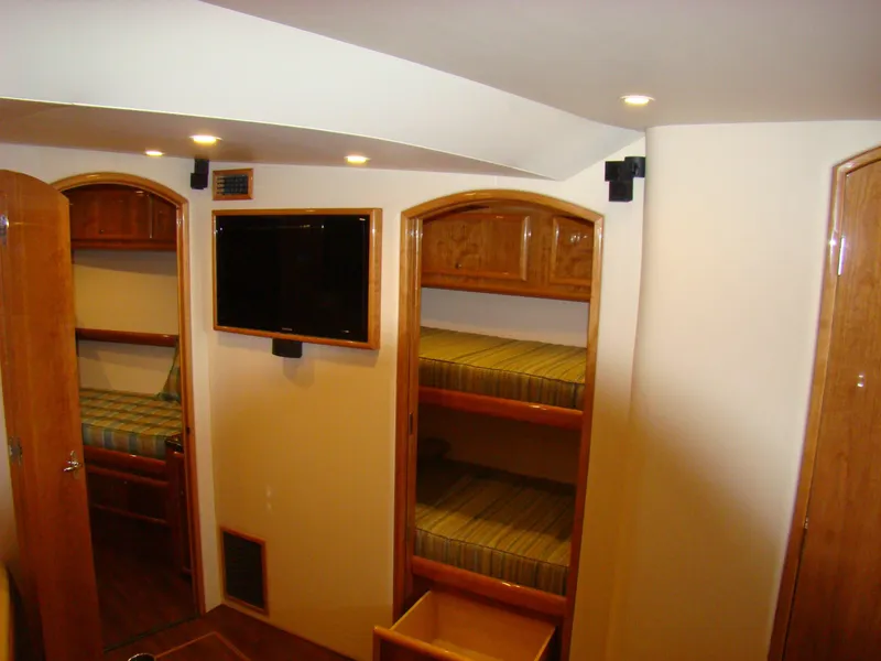 Slide: The Image of Interior of 2024 Jersey Cape 47 Custom Hardtop with bunk beds and TV. - 10