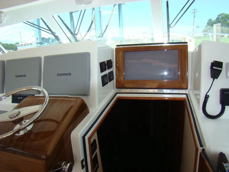 Slide: The Image of 2024 Jersey Cape 47 Custom Hardtop helm with Garmin electronics and wooden accents. - 12