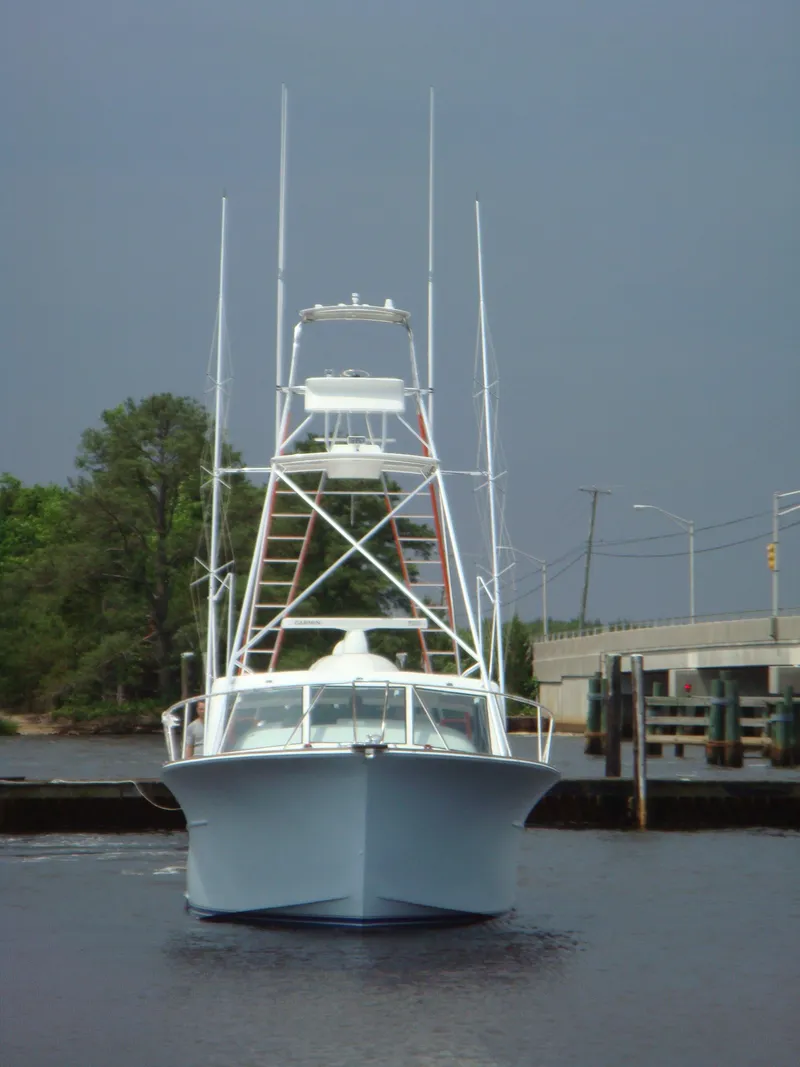 Slide: The Image of 2024 Jersey Cape 47 Custom Hardtop boat on water. - 2