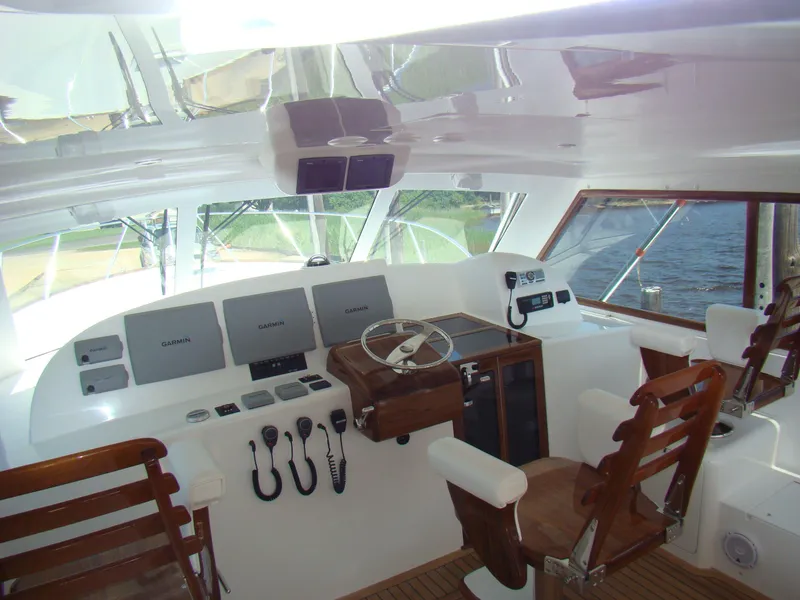 Slide: The Image of 2024 Jersey Cape 47 Custom Hardtop helm station with modern navigation equipment. - 21