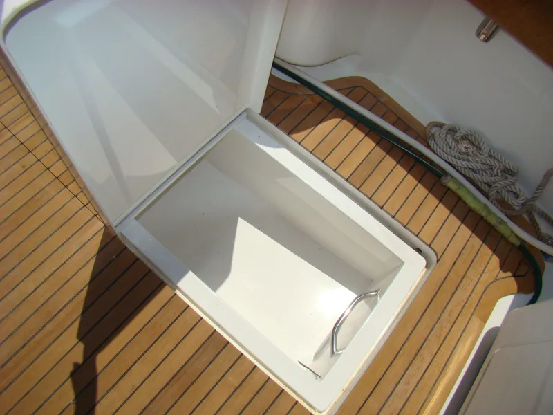 Slide: The Image of Open storage compartment on 2024 Jersey Cape 47 Custom Hardtop boat. - 26