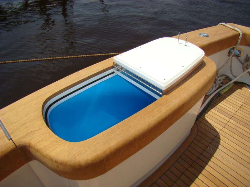 Slide: The Image of Jersey Cape 47 Custom Hardtop 2024 livewell on teak deck. - 28