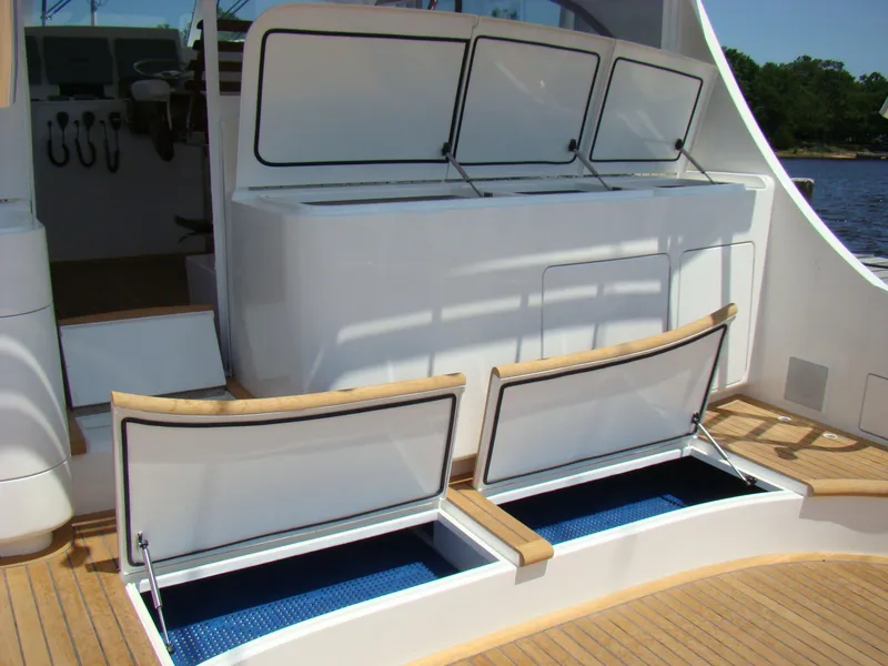 Slide: The Image of 2024 Jersey Cape 47 Custom Hardtop boat with open storage compartments. - 32