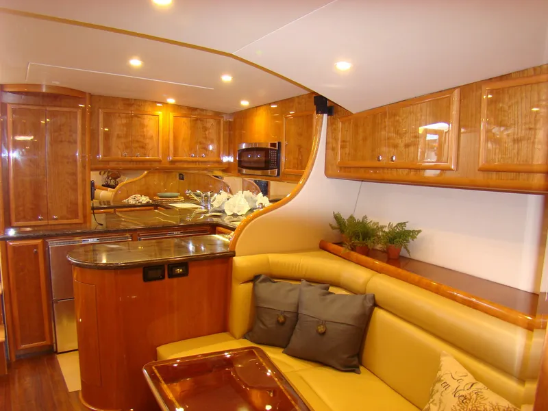 Slide: The Image of Luxurious interior of 2024 Jersey Cape 47 Custom Hardtop yacht with wooden cabinetry and leather seating. - 44