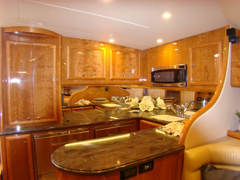 Slide: The Image of Luxurious kitchen interior of 2024 Jersey Cape 47 Custom Hardtop yacht with wooden cabinetry. - 45