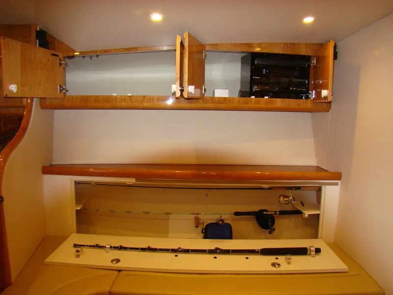 Slide: The Image of 2024 Jersey Cape 47 Custom Hardtop interior storage with fishing rod compartment. - 7