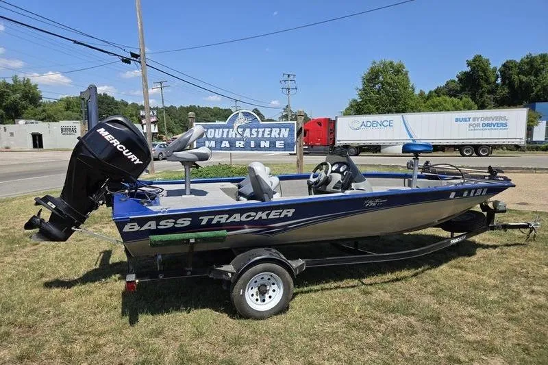 Slide: The Image of 2011 Tracker Pro Team 175 TF boat with Mercury engine on trailer, parked outdoors. - 8