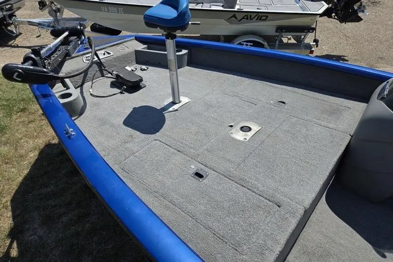Slide: The Image of 2011 Tracker Pro Team 175 TF fishing boat deck with blue trim and seating. - 9