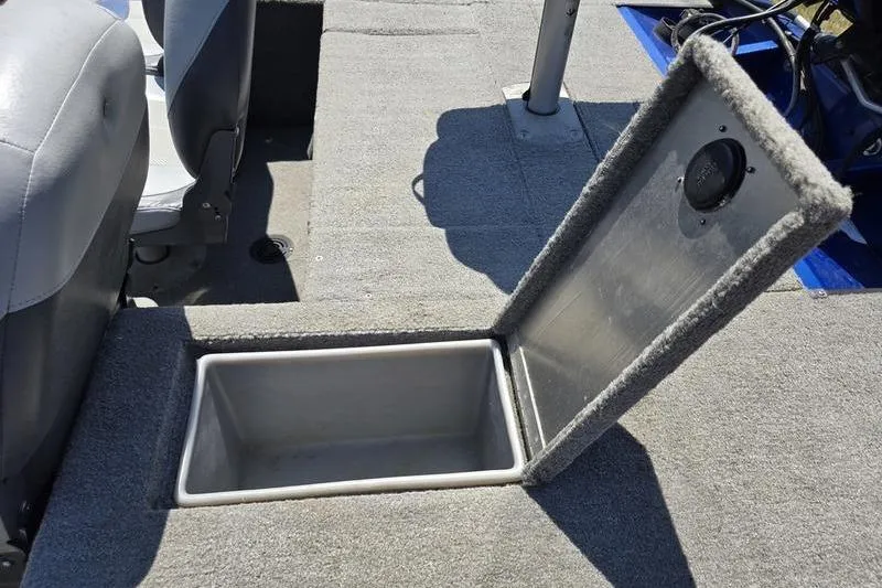 Slide: The Image of 2011 Tracker Pro Team 175 TF boat with open storage compartment on carpeted deck. - 4