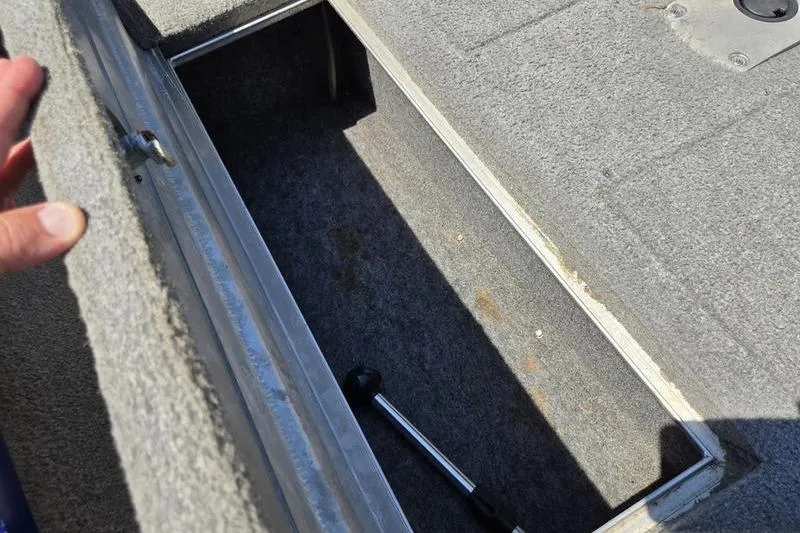 Slide: The Image of Open storage compartment in 2011 Tracker Pro Team 175 TF boat, showing interior space. - 13
