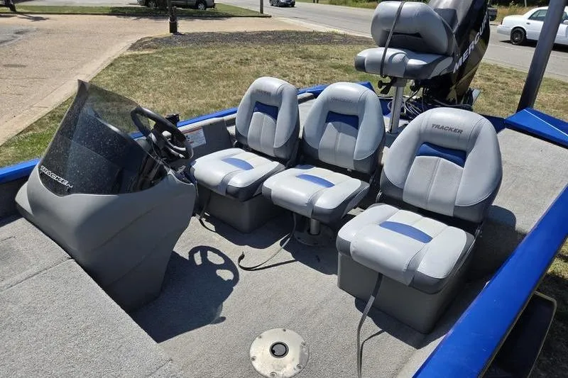 Slide: The Image of 2011 Tracker Pro Team 175 TF boat interior with three gray seats and steering console. - 12