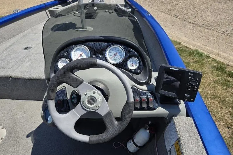 Slide: The Image of 2011 Tracker Pro Team 175 TF boat dashboard with steering wheel and gauges. - 15