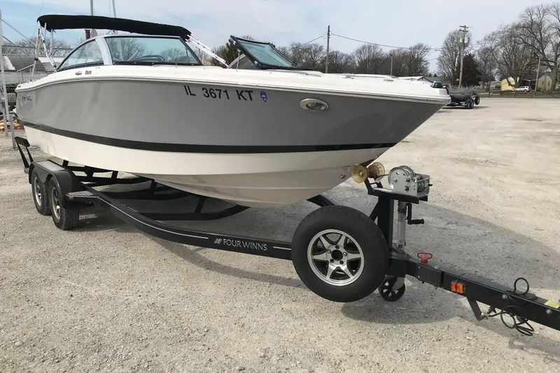 Slide: The Image of 2015 Four Winns H230 boat on trailer in parking lot. - 10