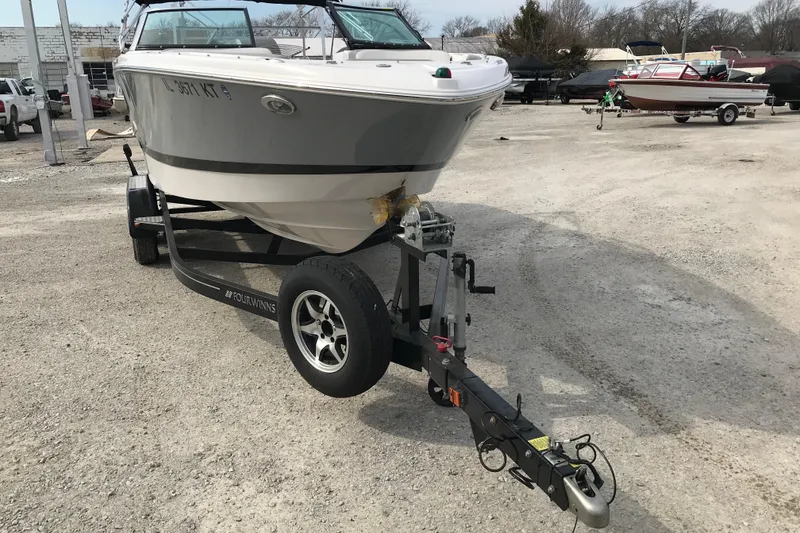 Slide: The Image of 2015 Four Winns H230 boat on trailer in outdoor lot. - 11