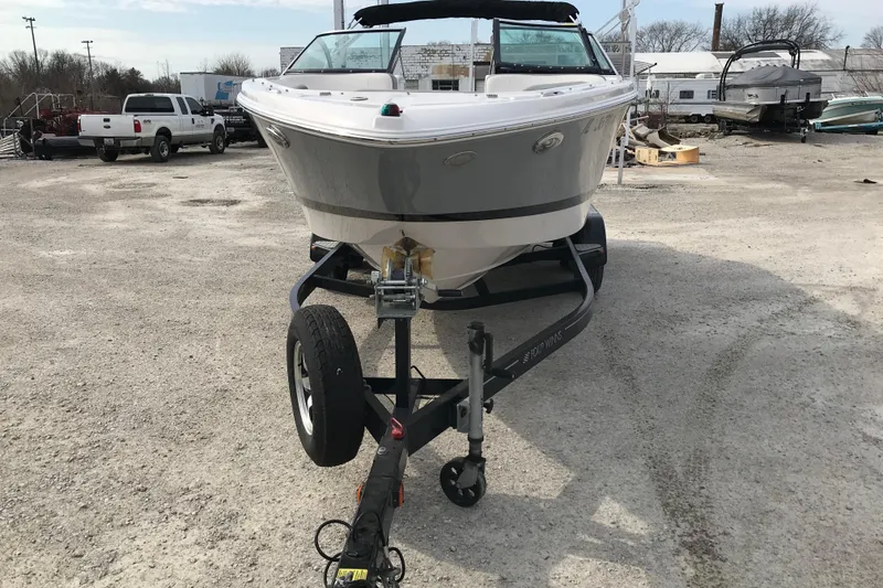 Slide: The Image of 2015 Four Winns H230 boat on trailer in outdoor setting. - 12