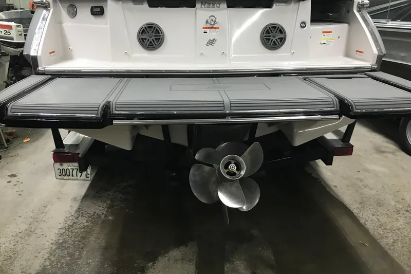 Slide: The Image of Rear view of 2015 Four Winns H230 boat with propeller and swim platform. - 29