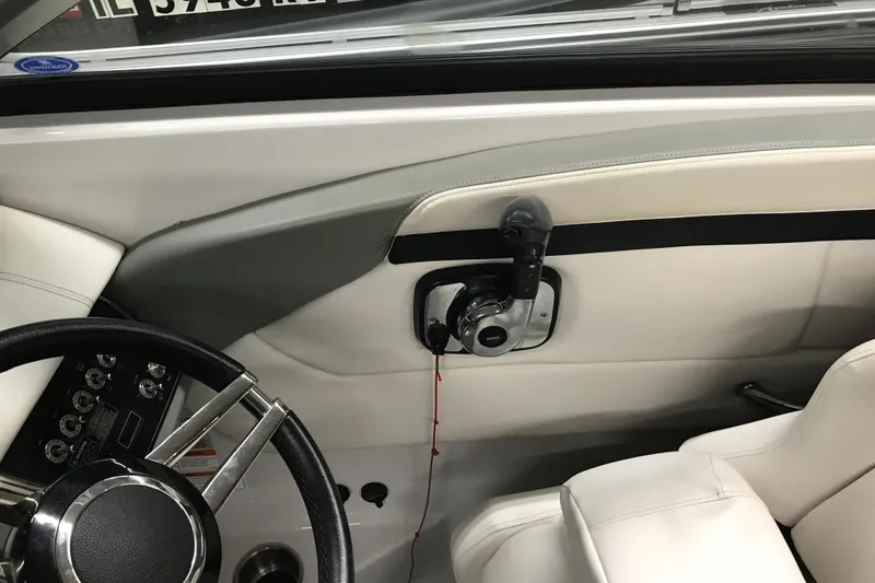Slide: The Image of Interior view of 2015 Four Winns H230 boat cockpit with steering wheel and controls. - 32