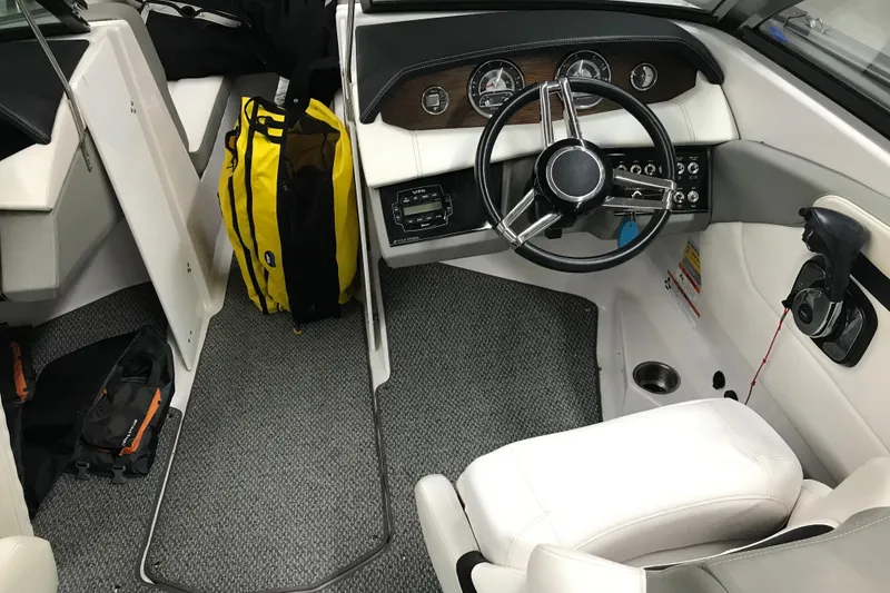 Slide: The Image of Interior of 2015 Four Winns H230 boat with steering wheel and dashboard. - 35