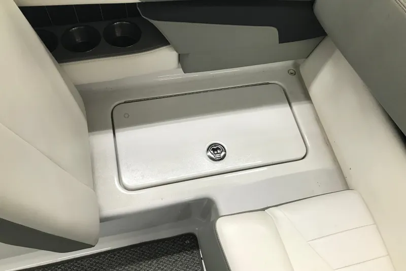 Slide: The Image of Interior of 2015 Four Winns H230 boat showing storage compartment and cup holders. - 37