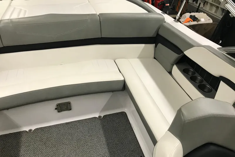 Slide: The Image of 2015 Four Winns H230 boat interior with gray and white seating and cup holders. - 45