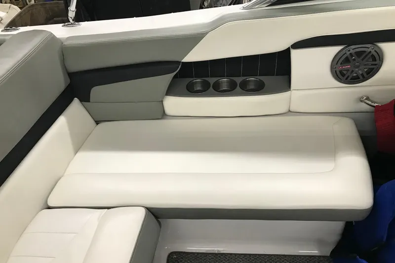 Slide: The Image of 2015 Four Winns H230 boat interior with white seating and cup holders. - 63