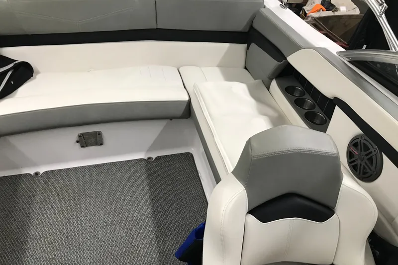 Slide: The Image of Interior of 2015 Four Winns H230 boat with cushioned seating and cup holders. - 64