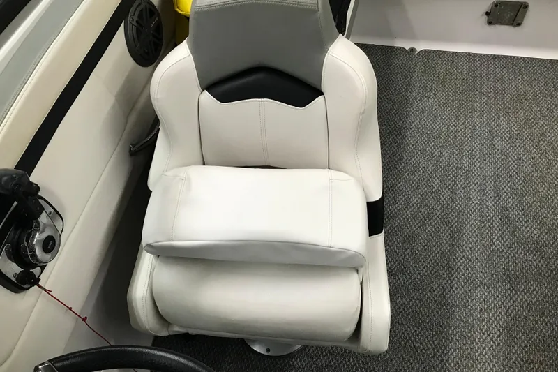 Slide: The Image of Captain's seat in 2015 Four Winns H230 boat, featuring white upholstery and modern design. - 66