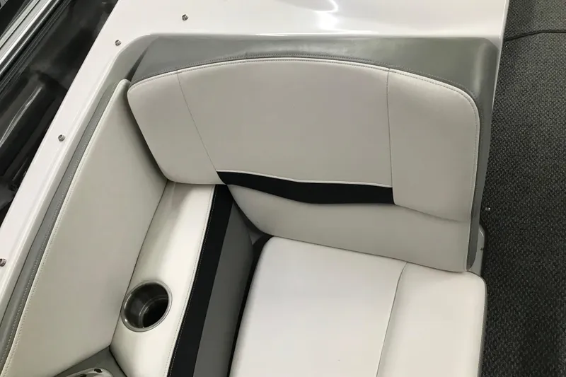Slide: The Image of 2015 Four Winns H230 boat interior with white and gray seating and cup holder. - 73