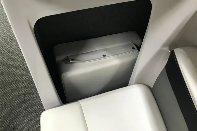 Slide: The Image of Storage compartment in 2015 Four Winns H230 boat with white cushioned seating. - 75