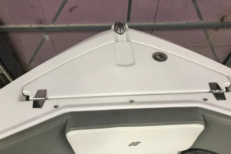 Slide: The Image of Bow area of a 2015 Four Winns H230 boat, featuring sleek white design and stainless steel fittings. - 78