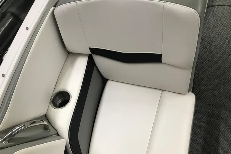 Slide: The Image of 2015 Four Winns H230 boat interior with white and gray seating, cup holder, and handle. - 79