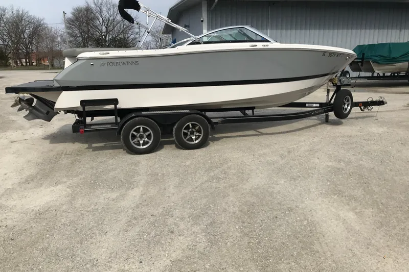 Slide: The Image of 2015 Four Winns H230 boat on trailer, parked outdoors. - 8
