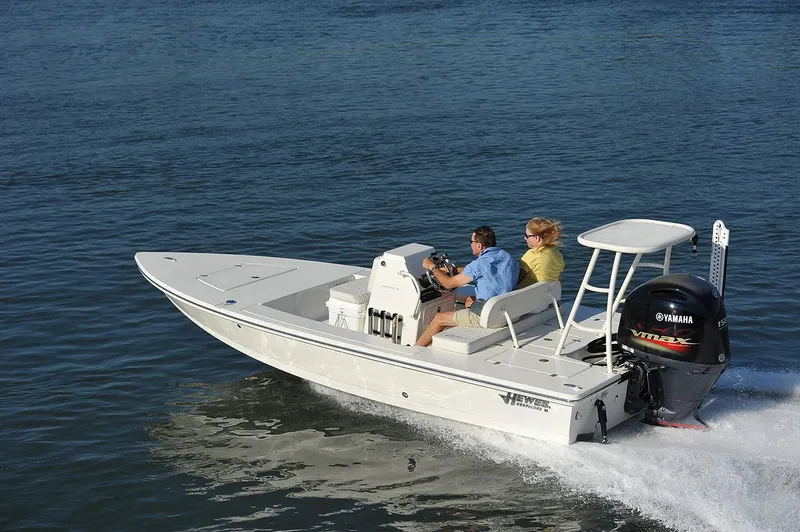 The Image of 2024 Hewes 18 Redfisher boat cruising on water with two passengers. - 1