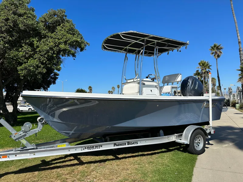 Slide: The Image of 2024 Parker 1801 Center Console boat on trailer, parked on grass, sunny day. - 1