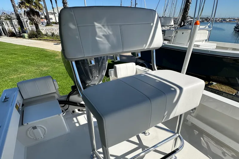 Slide: The Image of 2024 Parker 1801 Center Console boat with cushioned seating at the dock. - 6