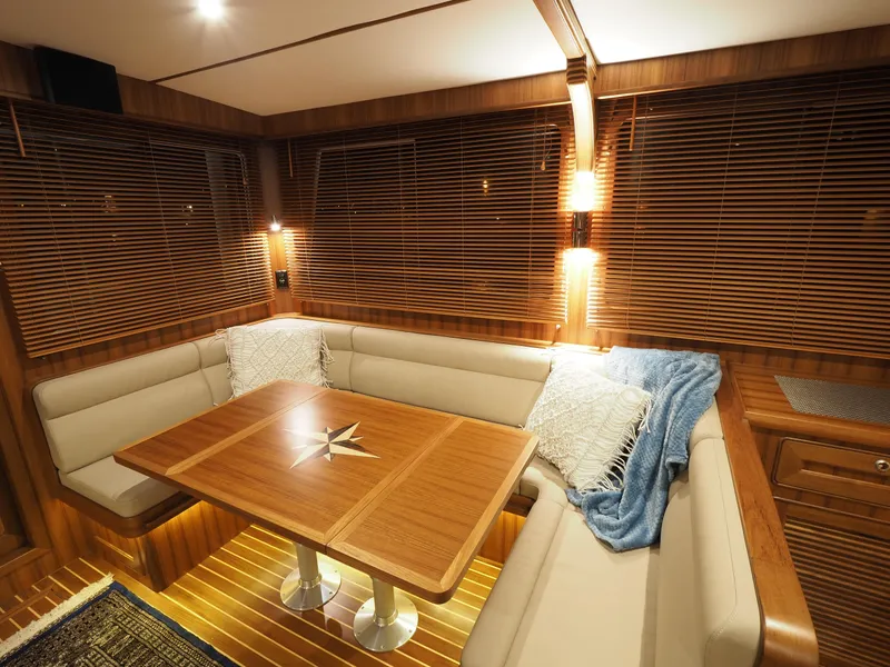 Slide: The Image of Luxurious interior of 2026 Helmsman Trawlers 43E PILOTHOUSE with elegant wood finishes and cozy seating. - 10