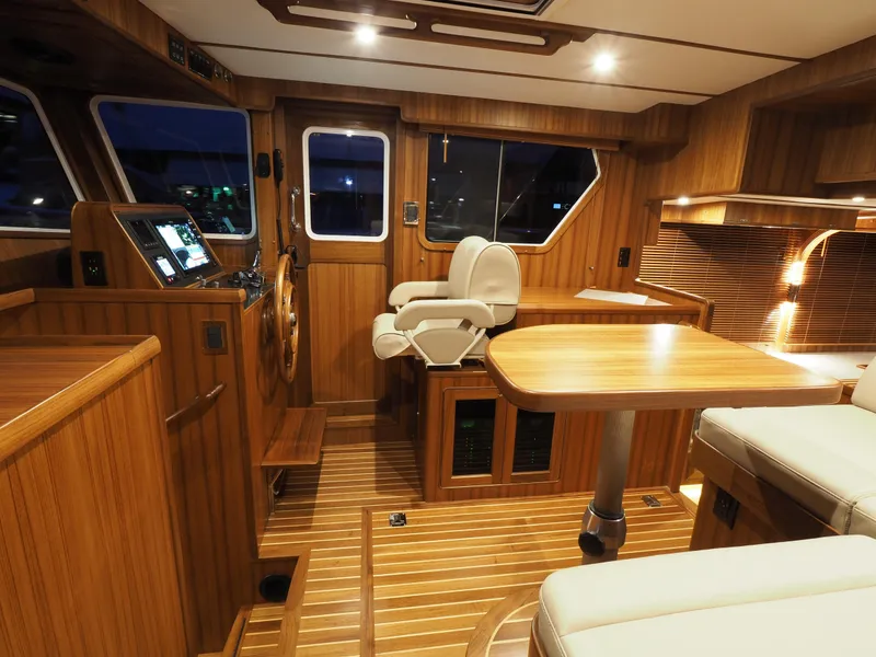 Slide: The Image of Luxurious interior of 2026 Helmsman Trawlers 43E Pilothouse with wood finish and modern amenities. - 14