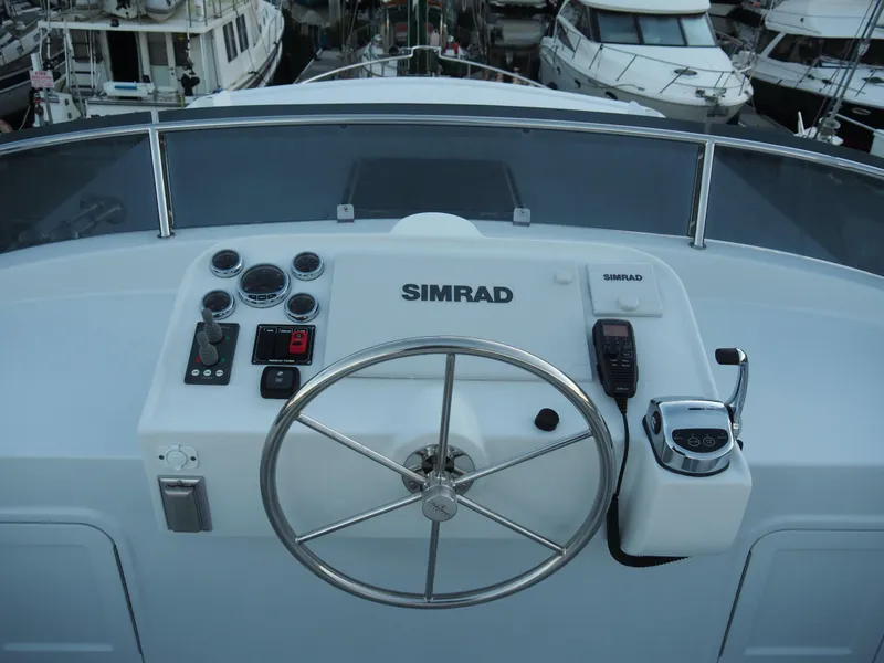 Slide: The Image of Helmsman Trawlers 43E PILOTHOUSE 2026 helm with Simrad controls and steering wheel. - 36