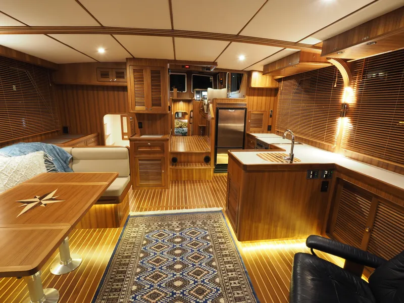 Slide: The Image of Luxurious interior of 2026 Helmsman Trawlers 43E PILOTHOUSE with wood finishes and modern amenities. - 4