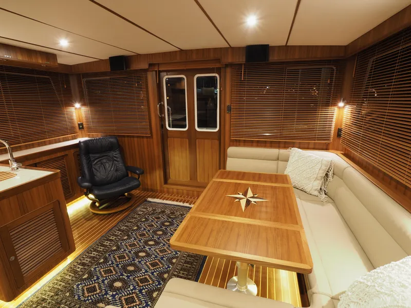 Slide: The Image of Luxurious interior of 2026 Helmsman Trawlers 43E Pilothouse with elegant wood finishes. - 8