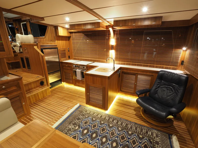 Slide: The Image of Luxurious interior of 2026 Helmsman Trawlers 43E Pilothouse with wood finish and modern amenities. - 9
