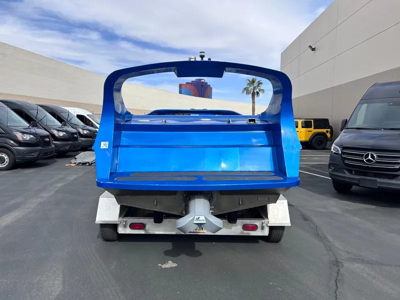 Slide: The Image of Blue 2021 Smoky Mountain 12 Passenger vehicle parked in a lot with vans. - 5