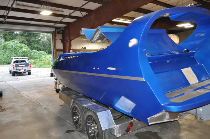 Slide: The Image of Blue 2021 Smoky Mountain 12 Passenger boat on trailer in a garage. - 9